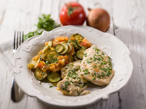escalope with tomatoes and zucchinis, selective focus