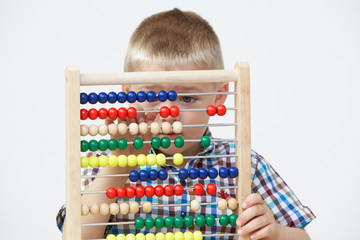 Studio Shot Of Boy Playing With Abacus