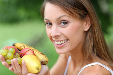 Beautiful girl eating organic fruits