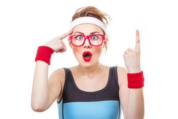 Surprised fitness woman gesturing finger up