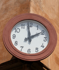 big and circular wall clock that marks the two o'clock