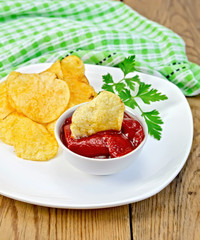 Chips with tomato sauce on the board
