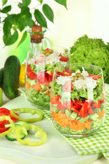 Tasty salad with fresh vegetables on wooden table