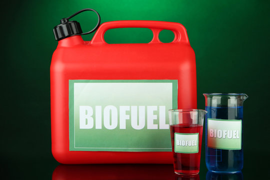 Bio fuels in canister and vials on green  background