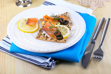Salmon sandwiches on plate  on wooden table close-up