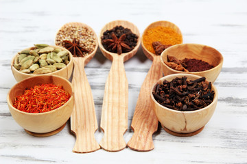 Various spices and herbs on wooden background
