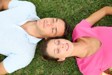 View from above of couple resting in grass