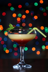Tasty  blackberry cocktail on bright background