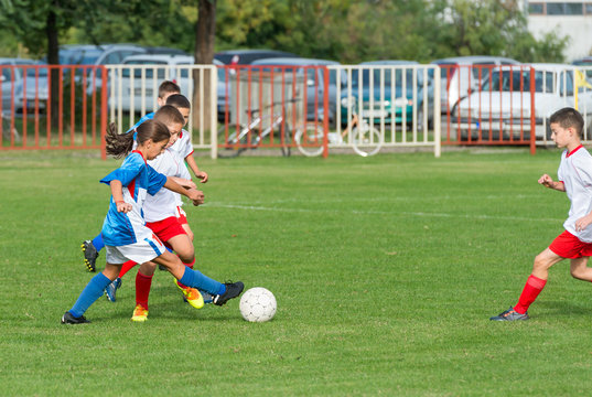 little girl playing kid's soccer