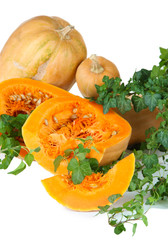 Ripe cut pumpkins with leaves isolated on white