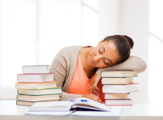 tired student with books and notes