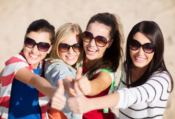 teenage girls or young women showing thumbs up