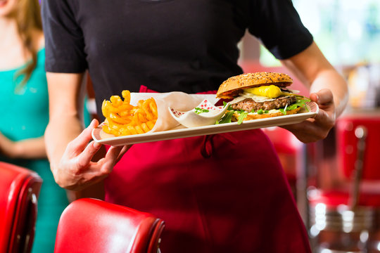 Waitress Serving In American Diner Or Restaurant