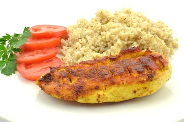 fried chicken breast fillet with grits and tomato