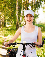 Obraz premium Woman riding bicycle outside.