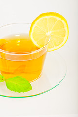 tea in cup with leaf mint and lemon