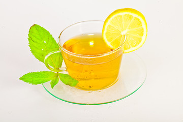 tea in cup with leaf mint and lemon