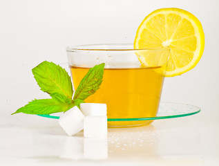 tea in cup with leaf mint and lemon