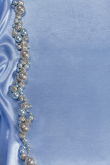 Delicate satin background with beads