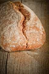 Freshly baked traditional bread on wooden table 