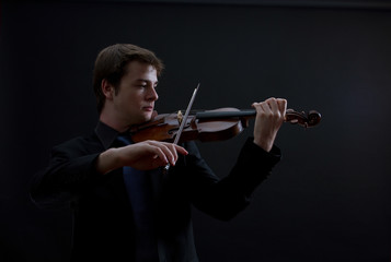 Virtuoso Teen Male Violinist on Dark Background