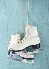 Pair of  ice skates on blue wooden background