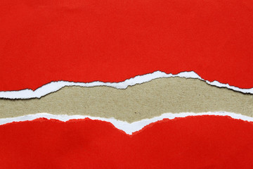 Ripped red paper on brown background. Copy space