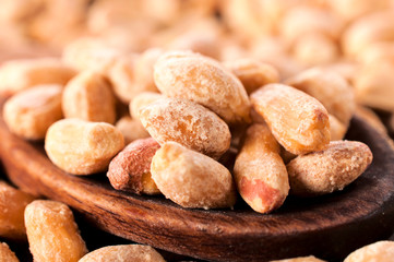 Peanuts on wooden spoon