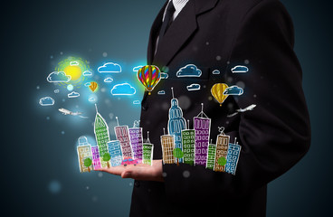 Young businessman presenting colorful hand drawn metropolitan ci