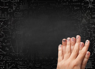 Happy finger smileys with black chalkboard in background