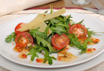 salad of arugula and cherry tomatoes with parmesan sauce