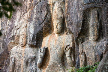 Buddha statues carved in rock at Buduruvagala temple in Sri Lank