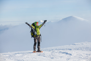 Hiker posing at camera in winter mountains