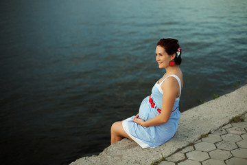 Fototapeta na wymiar Pregnant caucasian woman takes rest outdoor
