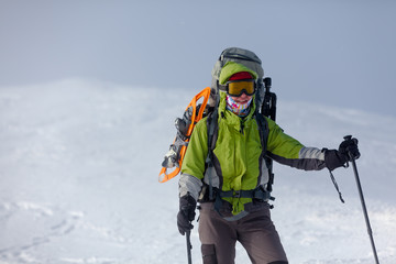 Fototapeta na wymiar Hiker posing at camera in winter mountains
