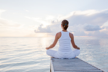 Caucasian woman practicing yoga at seashore © Maygutyak