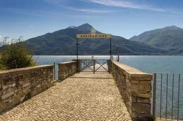 Papier Peint photo autocollant Jetée Beautiful lake Como with empty wooden pier giving a warm relaxin