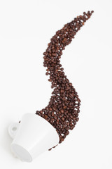 Cup of coffee and some coffee bean