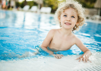 Little blondie girl in the swimming pool