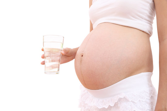 Fresh water drinking of pregnant woman on white background.