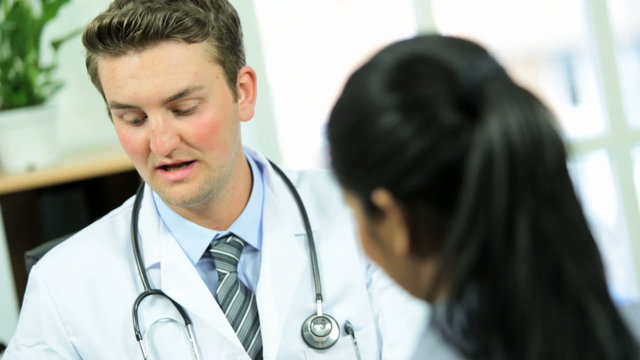 Male Doctor Showing Patient Medical Test Results