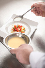 Serving the dish. Close-up top view of chef preparing an order