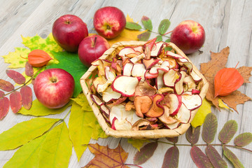 fresh and dried apples on autumn leaves