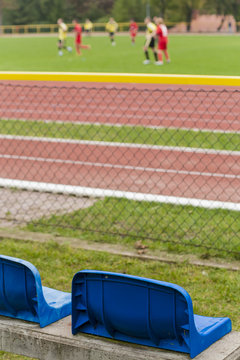 Training of football players watched from a chair.