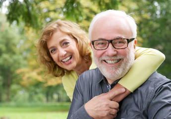 Fototapeta premium Happy older woman embracing smiling older man