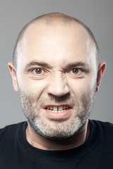 portrait of angry man isolated on gray background
