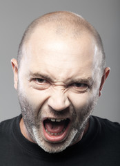 Obraz premium portrait of angry man sreaming isolated on gray background