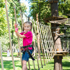 little girl  in a rope park