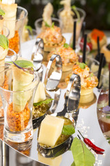 canape with meat seafood and vegetables on a white background