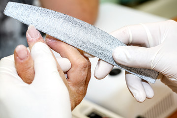 processes work on a manicure in the salon